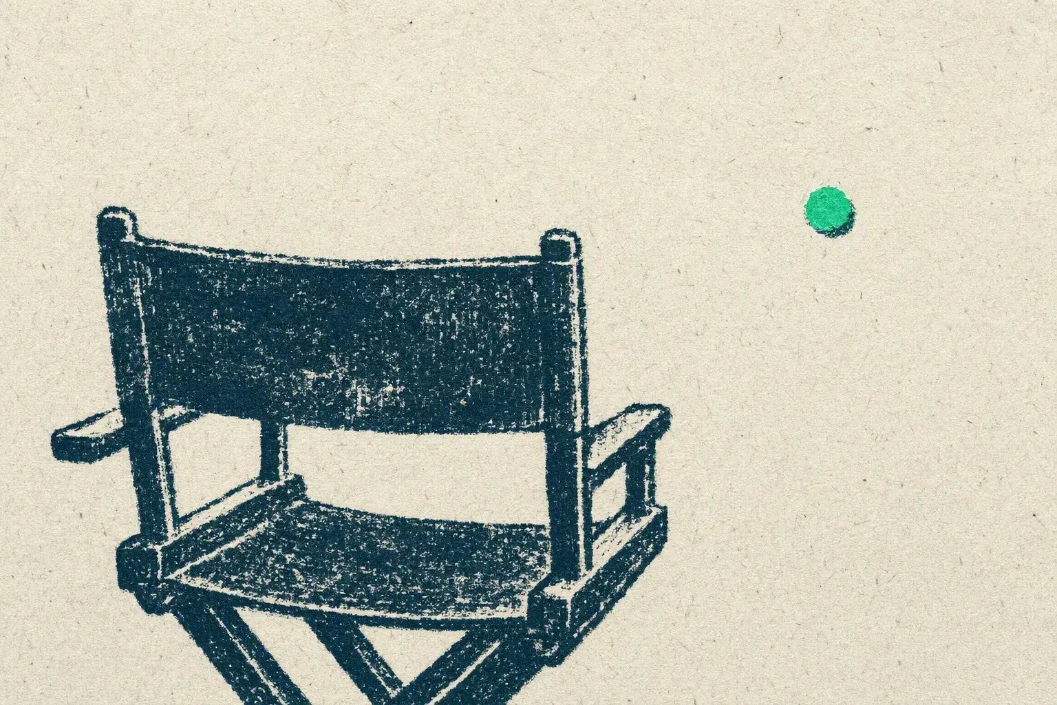 The back of a director's chair facing a wide empty stage, one green mark far out where the scene will be